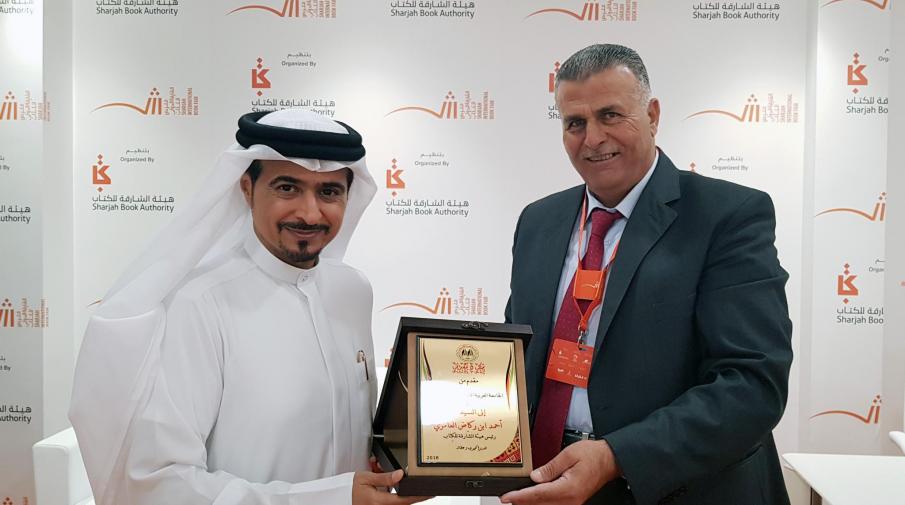 Honoring the Chairman of the Sharjah Book Authority Ahmed bin Rakad Al Ameri with University Armor